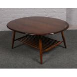 An Ercol style circular coffee table, with under tier.