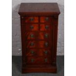 A mahogany chest of drawers with lockable columns.