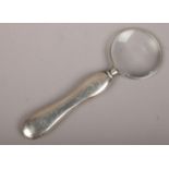 A silver handle magnifying glass, hallmarks faded.