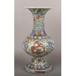 A 20th century Chinese Wucai glazed gu vase. Decorated with dragons on a ground of lotus scrolls,
