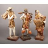 Three paper sculptures formed as farm labourers.