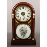 An early 20th century American simulated rosewood dome top postman's alarm clock by Seth Thomas.