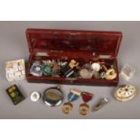 A Japanese lacquered glove box containing assorted collectables. Including enamelled lodge medals,