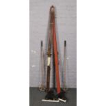 A set of Komperdell skiis with ski poles, along with a pair of Fagan ice skates.