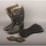 A set of motorcycle goggles along with a pair of leather boots and leather Slazenger gauntlets.