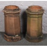 A pair of octagonal terracotta chimney pots, 63cm.