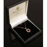 A 9ct gold pendant on chain set with red and white paste stones.