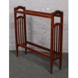 An Edwardian inlaid mahogany towel rail.