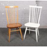 A pair of Ercol spindle back dining chairs, one painted white.