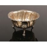 A George III Irish silver bowl with gadrooned rim and raised on three cabriole feet. Assayed
