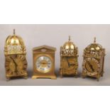 Three brass cased lantern clocks and another solid brass cased mantel clock with silvered chapter