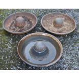 Three small Mexican hat shaped cast iron troughs.