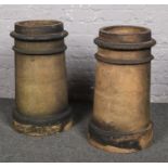 A pair of cylindrical terracotta chimney pots, 64cm.