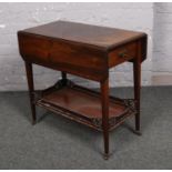 A mahogany pembroke table with under tier and single drawer.