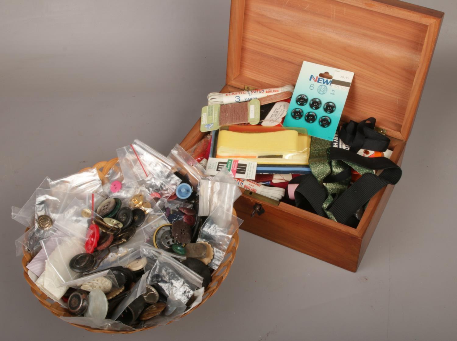 A wooden box and basket of sewing equipment, to include buttons, needles etc.