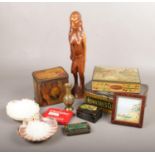 A group of collectables, to include vintage tins, wooden figure, shells etc.
