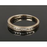 A 9ct gold and diamond half eternity ring, Size L. (1.51g).