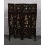 A small Chinese lacquered four fold screen inlaid with mother of pearl c.1930, 100cm Cracks to wood.