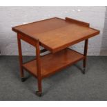 A teak metamorphic two tier tea trolley.