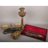 A cast set of W & T Avery kitchen scales, brass Corinthian column oil lamp, cased carving set and