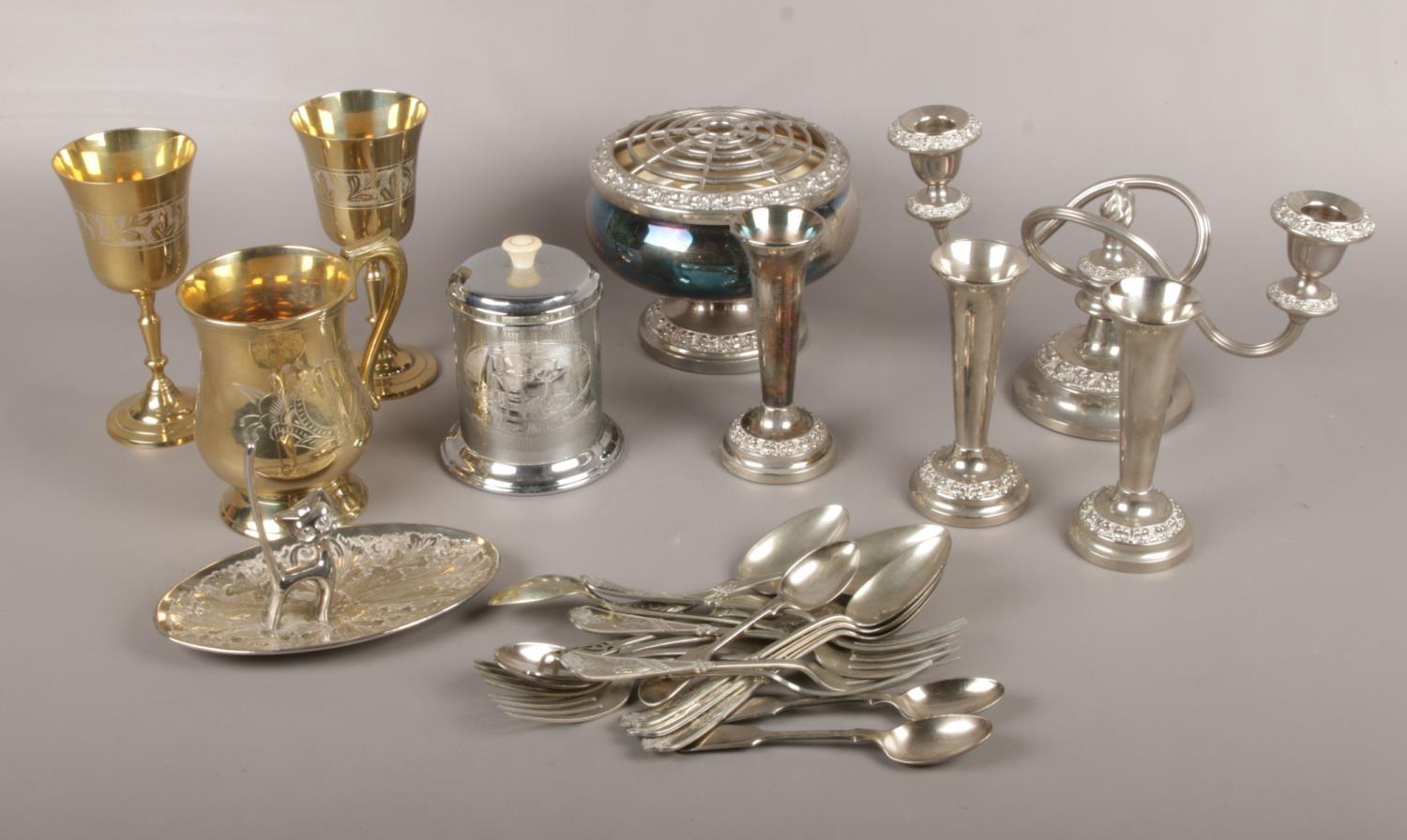 A collection of silver plate, candelabra, bud vases, goblets, cutlery etc