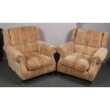 A pair of upholstered park knoll armchairs.