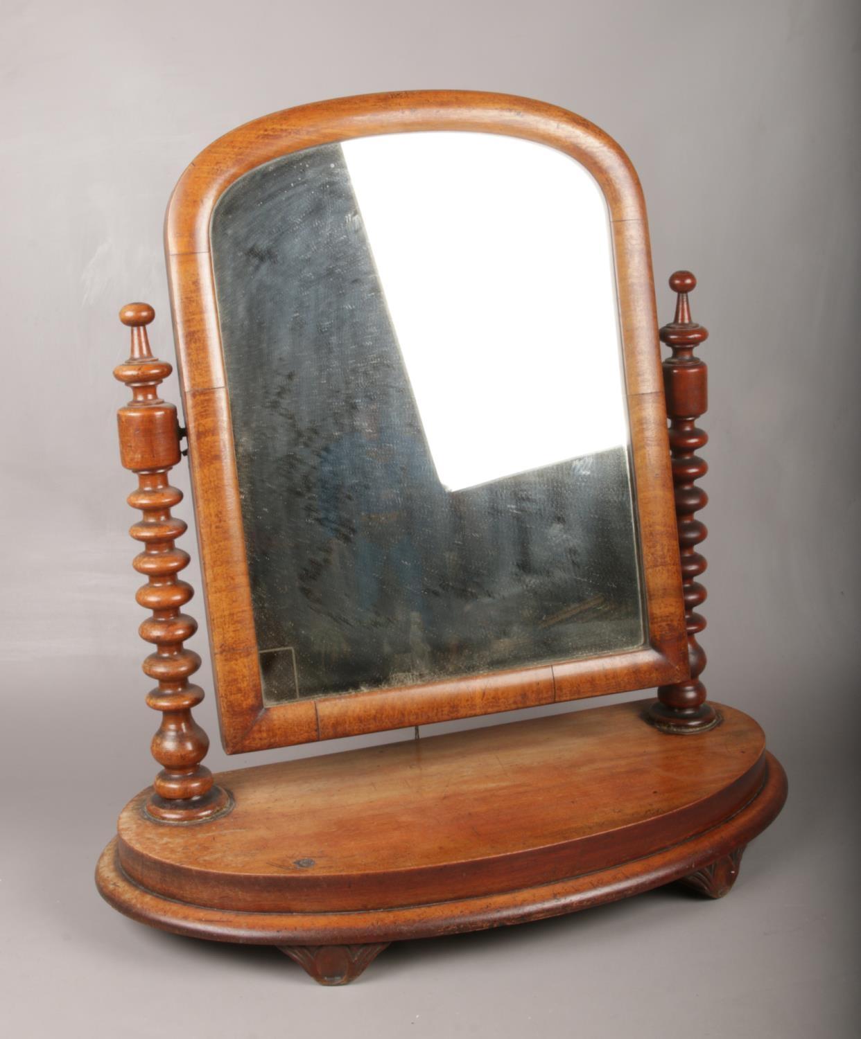 A Victorian mahogany toilet mirror, with bobbin turn column supports.