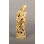 A Japanese Meiji period carved ivory okimono. Formed as a man with a monkey. Signed to the