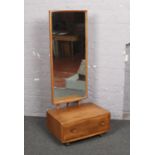 An Ercol light elm cheval mirror.