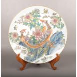 A large decorative Chinese charger, decorated with birds and flowers. (Diameter 46cm). Good