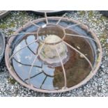 A vintage cast iron Mexican hat shaped trough with cage.