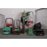 A Qualcast lawnmower and scarifier, a Black and Decker leaf vac and another lawmower.