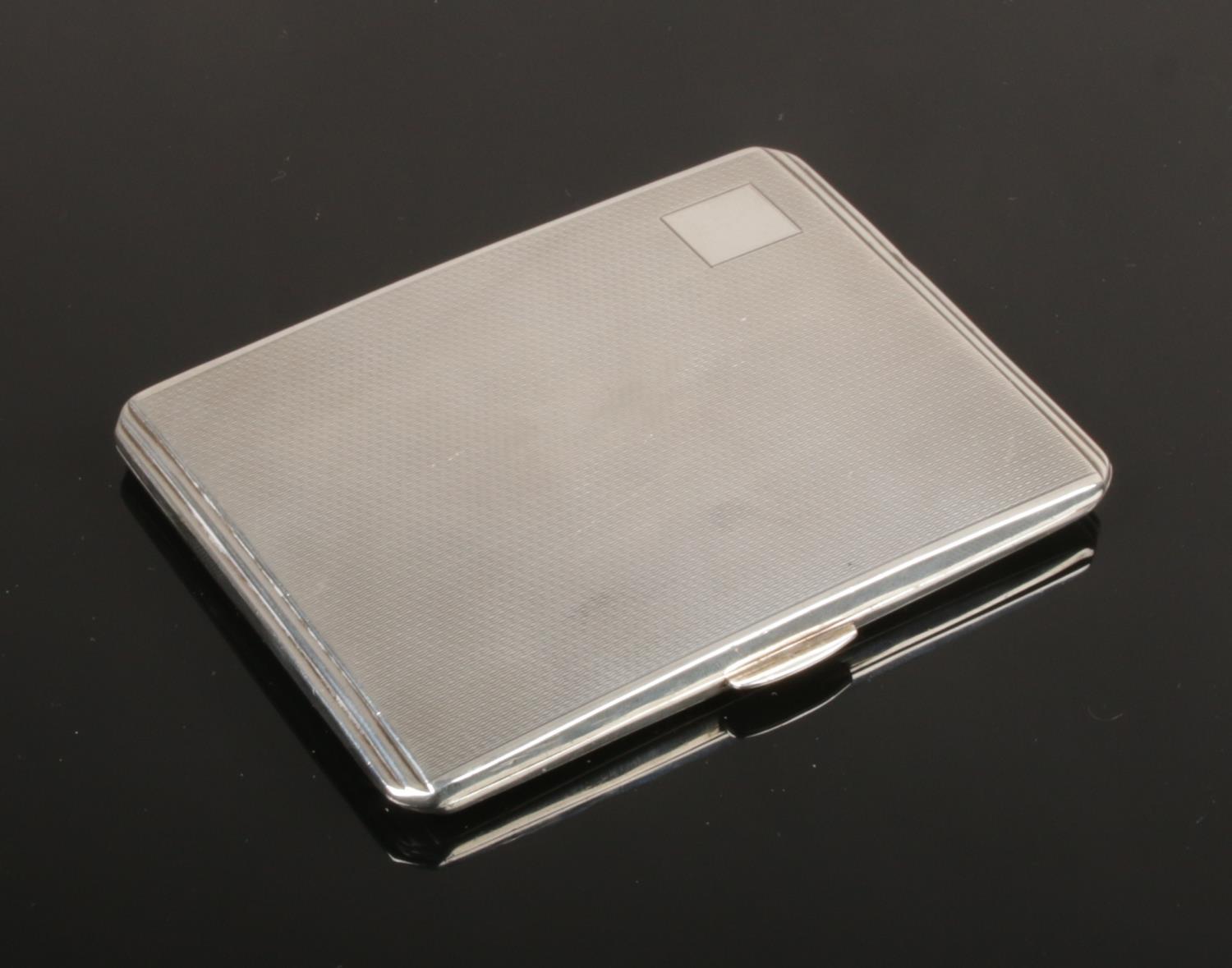 An Art Deco silver cigarette case with engine turned engraving by Smith & Bartlam. Assayed