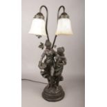 A composite figural table lamp, formed as two maidens.