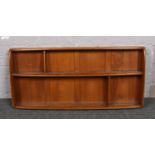 An Ercol light elm wall shelving rack.