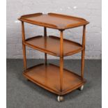 An Ercol light elm three tier tea trolley.