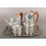 A four piece Piquot Ware teaset on stainless steel tray.