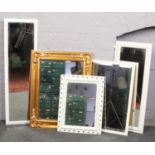A collection of mirrors, wooden/plastic frames, varying sizes.