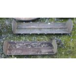 Two cast iron troughs.