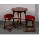 A mahogany bar table and two mahogany rush seat stools.