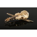 A 9ct gold, diamond and sapphire brooch, formed as a violin. 4.69g.