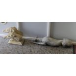 A cast garden statue formed as a recumbent greyhound and another the portrait bust of two hounds.