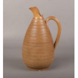 A 19th century Doulton Lambeth salt glazed stoneware ewer. with reeded strap handle and rouletted