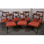 A collection of seven mahogany dinner chairs, two of these carver chairs.