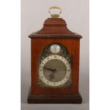 A small mahogany cased 8 day bracket clock. With brass arch top dial ornamented with spandrels. With