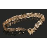 A 9ct gold gate bracelet with heart shape clasp. (4.32g).