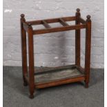 An oak stickstand with bobbin turned finials.