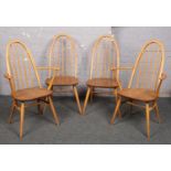 A set of four Ercol light elm spindle back dining chairs, including two carvers.