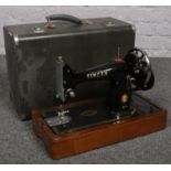 A cased Singer sewing machine.