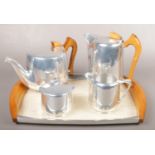 A four piece Piquot Ware teaset on Piquot Ware twin handle tray. Generally good condition.